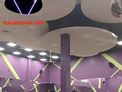 Masked woman exercises solo at the gym