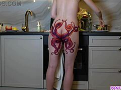 Mature milf with a tattoo on her ass seductively cooks dinner