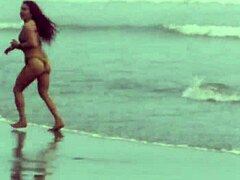 Sensuell milf-gudinne trener med strømpebånd på stranden i en dampende scene