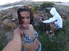 Arousing video of a young girl giving a blowjob on the rocks by the sea